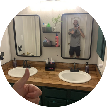 Custom wood plank countertop and double oval sink with matte black faucets.