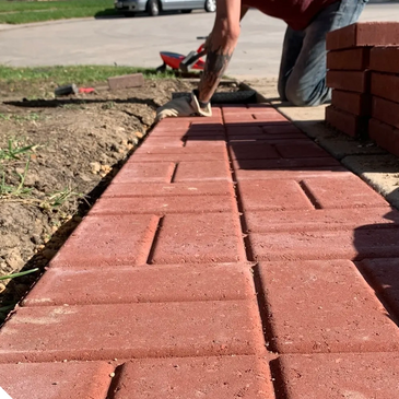 Brick pavers inset along driveway to provide space to walk without getting muddy in the rain.