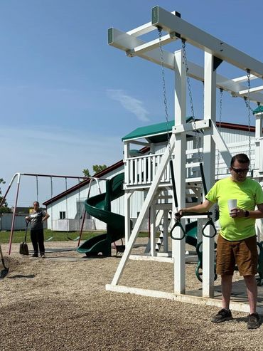 Volunteers helping spread mulch & Pea Gravel