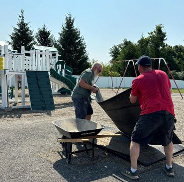 Volunteers helping spread mulch & Pea Gravel