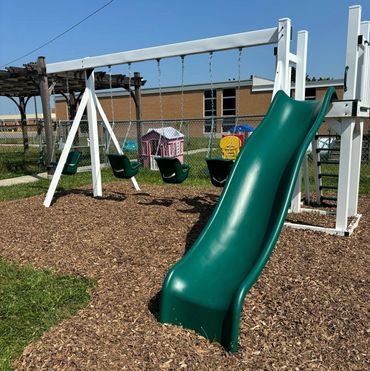 Volunteers helping spread mulch & Pea Gravel