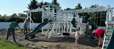 Volunteers helping spread mulch & Pea Gravel