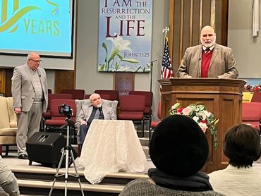 Pastor Jerry introducing guest speaker Dr. Phil Stringer.