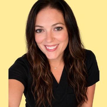 Smiling woman with long brown hair wearing a black top against a yellow background.