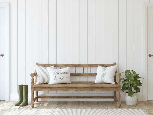 shiplap wall with wooden bench and green rubber boots