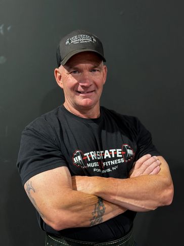 Man with crossed arms wearing fitness apparel.