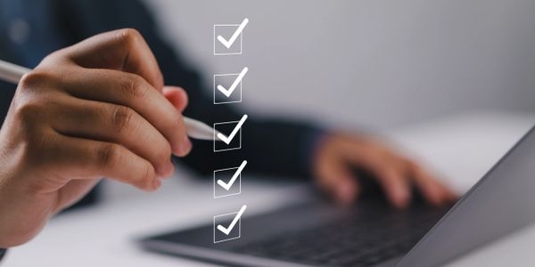 Hand checking off a list of completed tasks on a transparent interface.