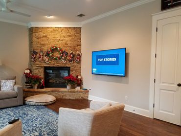 Another example of the invisible speakers; Three are pictured; Left, right, and below the TV.