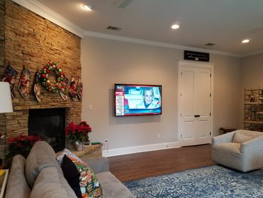 Another example of the invisible speakers; Three are pictured; Left, right, and below the TV.