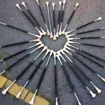 Batons arranged in a heart shape on the ground.