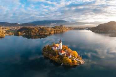 Island with a church in the middle of a lake.