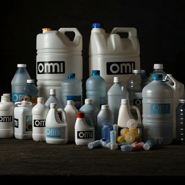 Various white and blue plastic containers labeled 'omi' on a dark background.