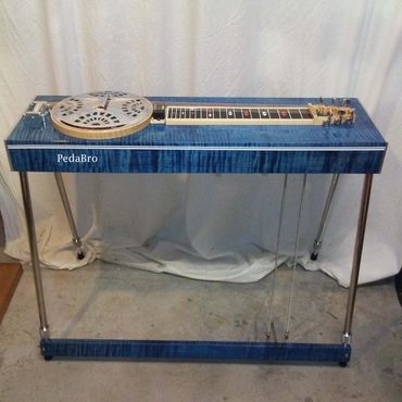 A blue resonator guitar on a steel pedal steel guitar frame.