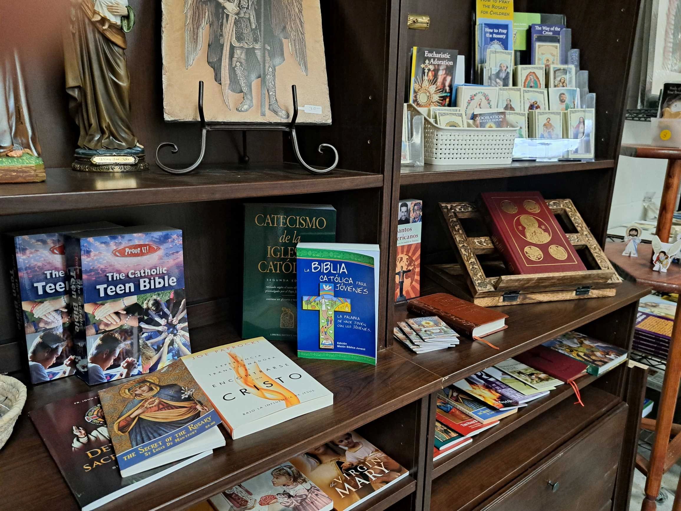 bookshelf with bibles , pamphlets and religious cards