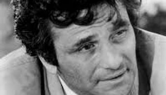 Black and white portrait of a man with curly hair in a suit.