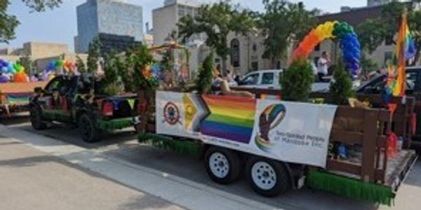 A colorful Pride parade float decorated with rainbow flags and banners.