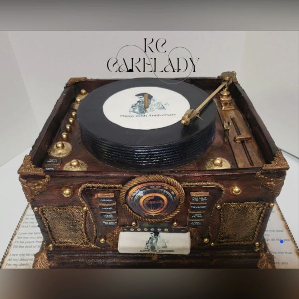 Vintage record player cake with intricate gold detailing.