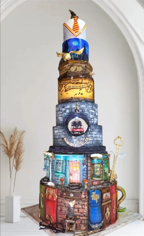 A detailed Harry Potter themed multi-tiered cake.