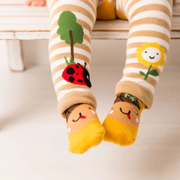 Child wearing striped leggings with animal and flower patterns.