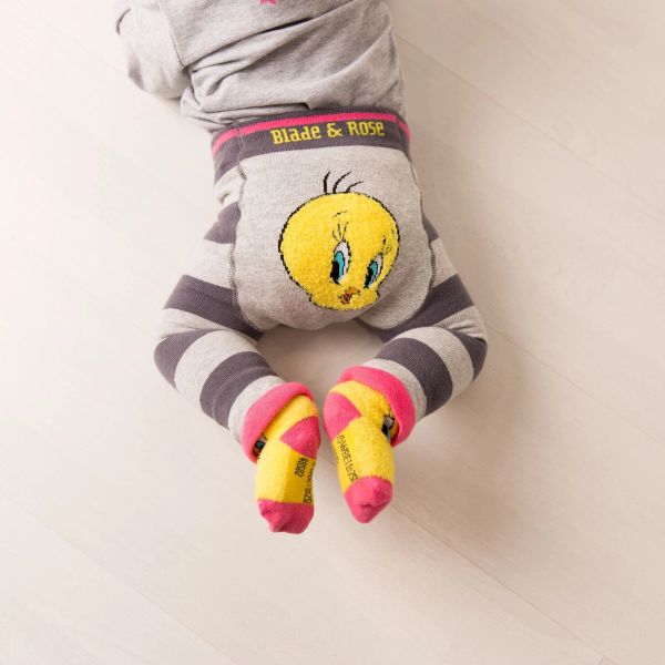 Baby wearing striped pants with Tweety Bird design.