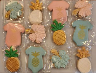 Colorful tropical-themed decorated cookies in plastic packaging.