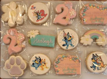 Colorful birthday-themed cookies featuring Bluey characters and decorations.