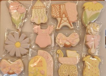 Decorative baby shower cookies with floral and baby-themed designs.