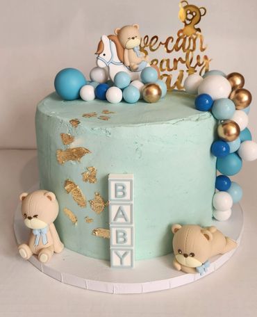 Blue baby shower cake with teddy bears and balloons for a baby shower