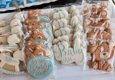 Decorative baby shower cookies with teddy bears, rocking horses, and "Baby Liam" designs.