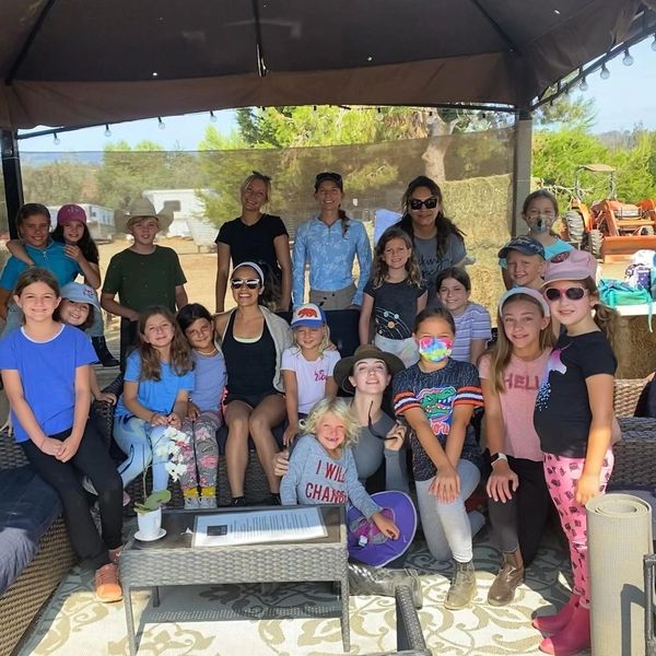 Parents with kids posing for a picture during horseback riding summer camp in san diego