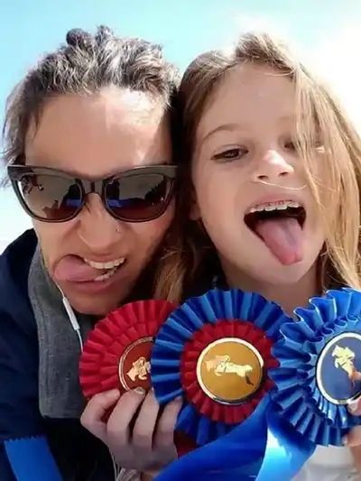 A mother and a girl posing for a picture