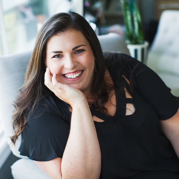 Libby Cole, Enneagram Coach, smiling with head resting on hand