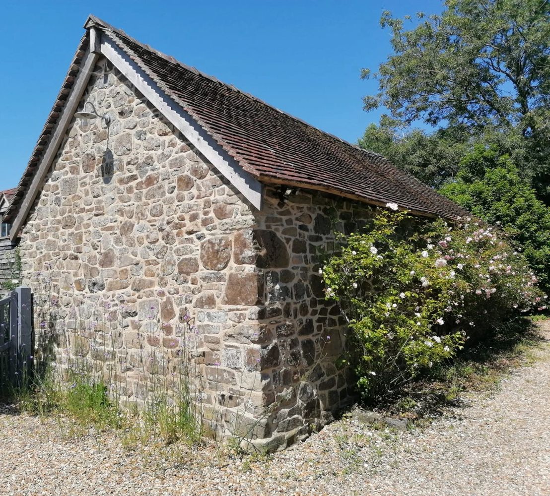 Lime repointing of stone out building in rural Shropshire. fixing of stone work