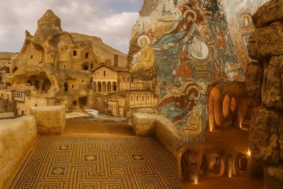 Ancient cave dwellings with intricate floor mosaics and religious frescoes.