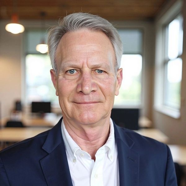 Smiling older man in business attire in office.