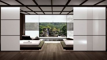 Minimalist bedroom with twin beds and a large window overlooking a serene waterfall.