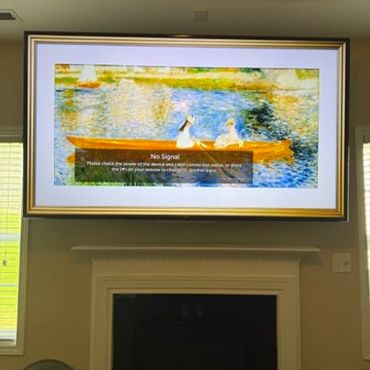 86" television mounted above fireplace shows a painting background. Installed by King of Mounts.
