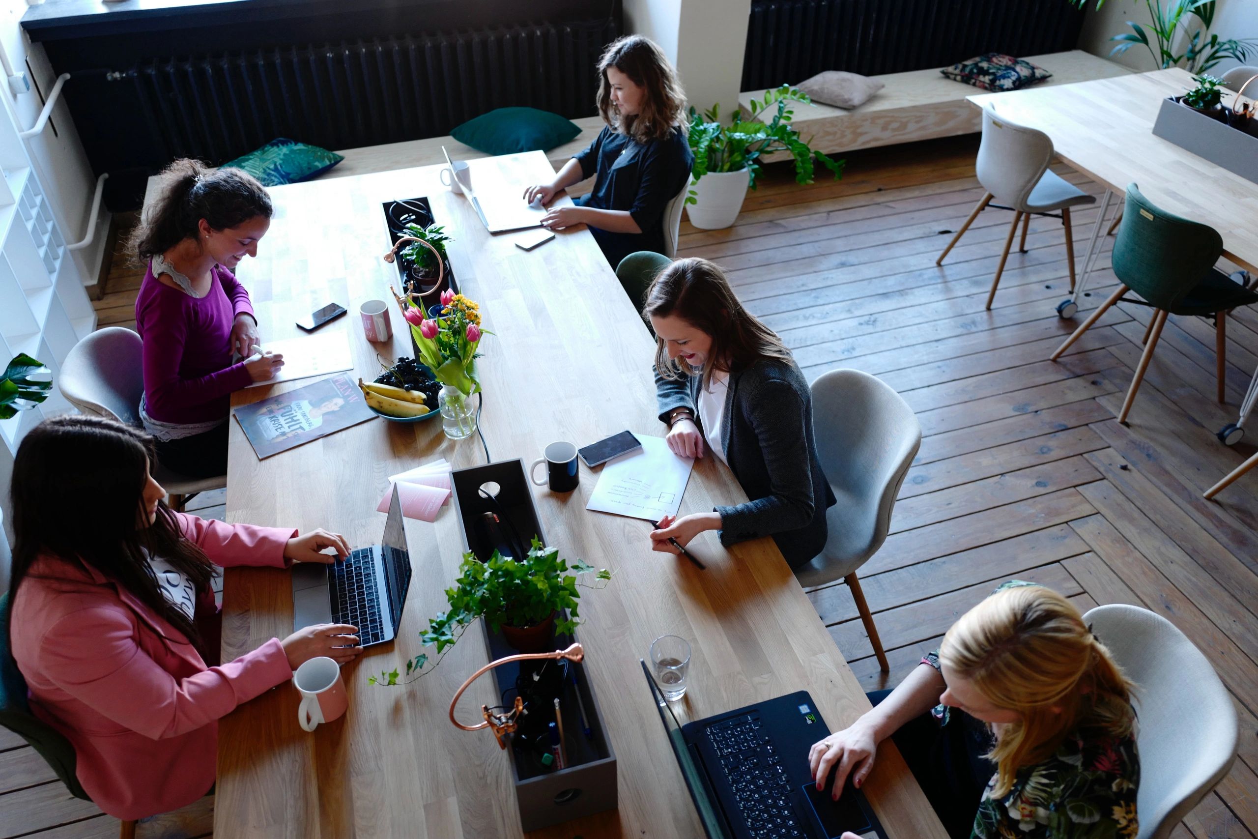 Group of women working collaboratively in open workspace