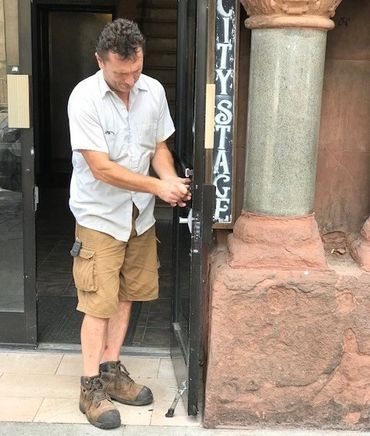 Locksmith at customer location installing door lock