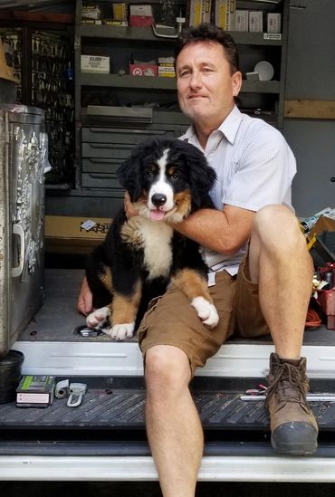 Locksmith with cute Bernese Mountain dog puppy