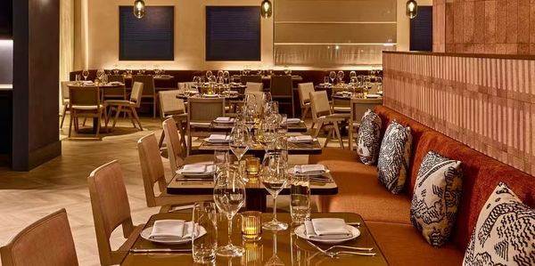 Elegant restaurant interior with warm lighting and cozy seating.