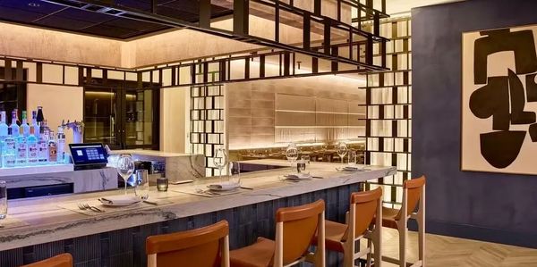 Modern restaurant bar with elegant seating and ambient lighting.