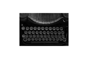 Close-up of a vintage typewriter keyboard in black and white.