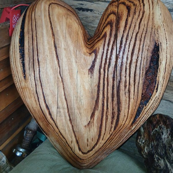 Heart-shaped wooden object with natural grain patterns.