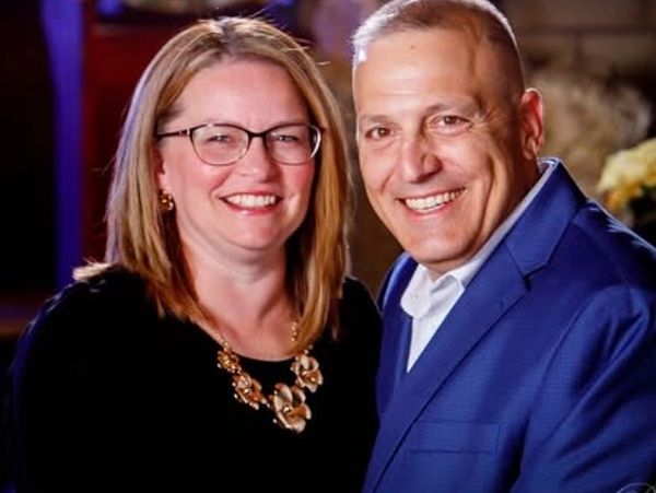 Smiling couple posing together indoors.