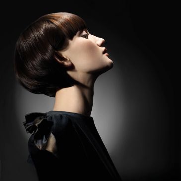 Glossy dark brunette bob with a sleek, sculpted finish and brilliant shine.