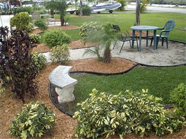 Patio table stone bench landscaping.