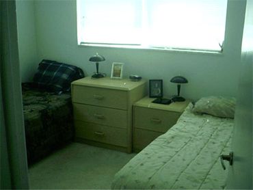 Bedroom nightstands twin beds window.