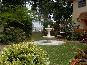 Fountain and lush front yard.