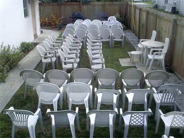 Backyard plastic chairs event setup.